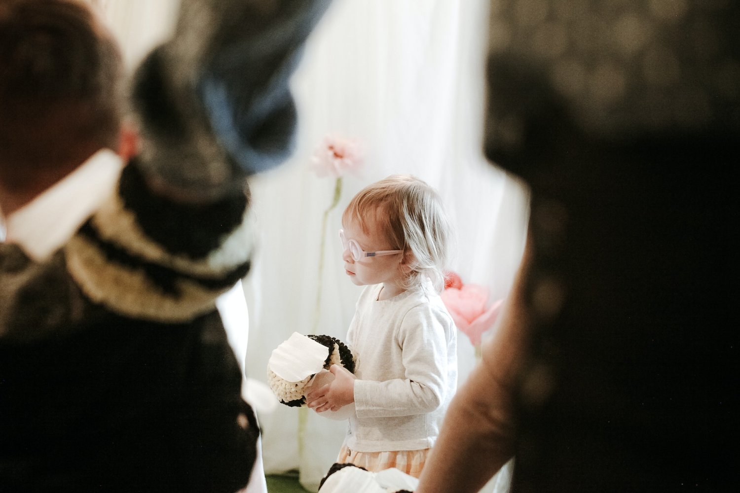 Dziewczynka w okularach, idzie za tłumem innych dzieci.