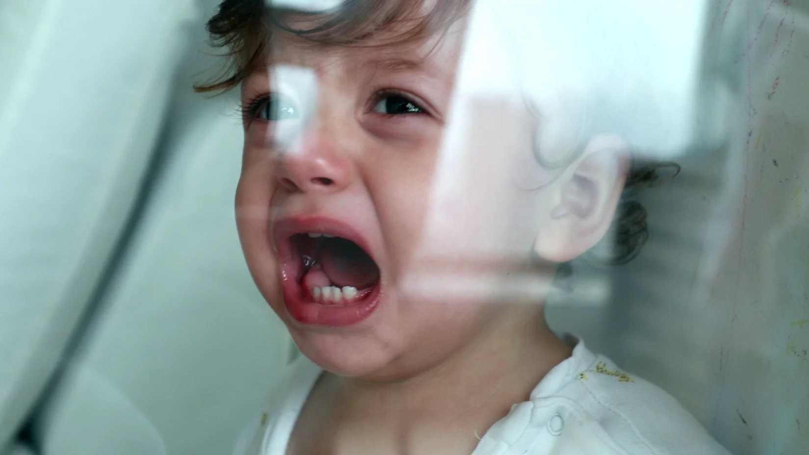 Na zdjęciu mały chłopiec płacze.