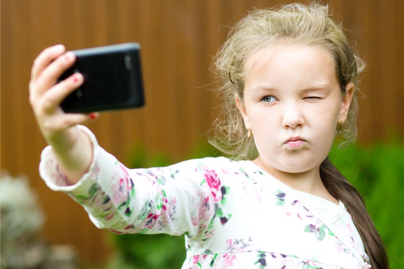 Mała dziewczynka robi sobie selfie.
