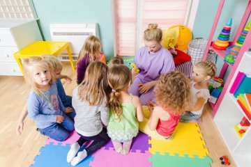 dzieci w przedszkolu pod opieką nauczycielki