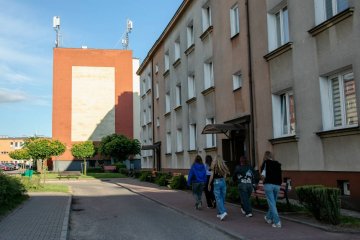 Nastolatki idące przez osiedle bloków.