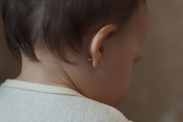 przekłucie uszu u niemowlaka wywołuje kontrowersje
