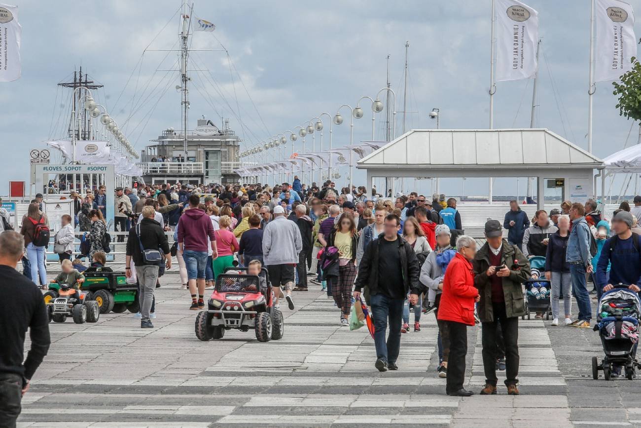 Dzieci w elektrycznych samochodach jeżdżą po sopockim molo.
