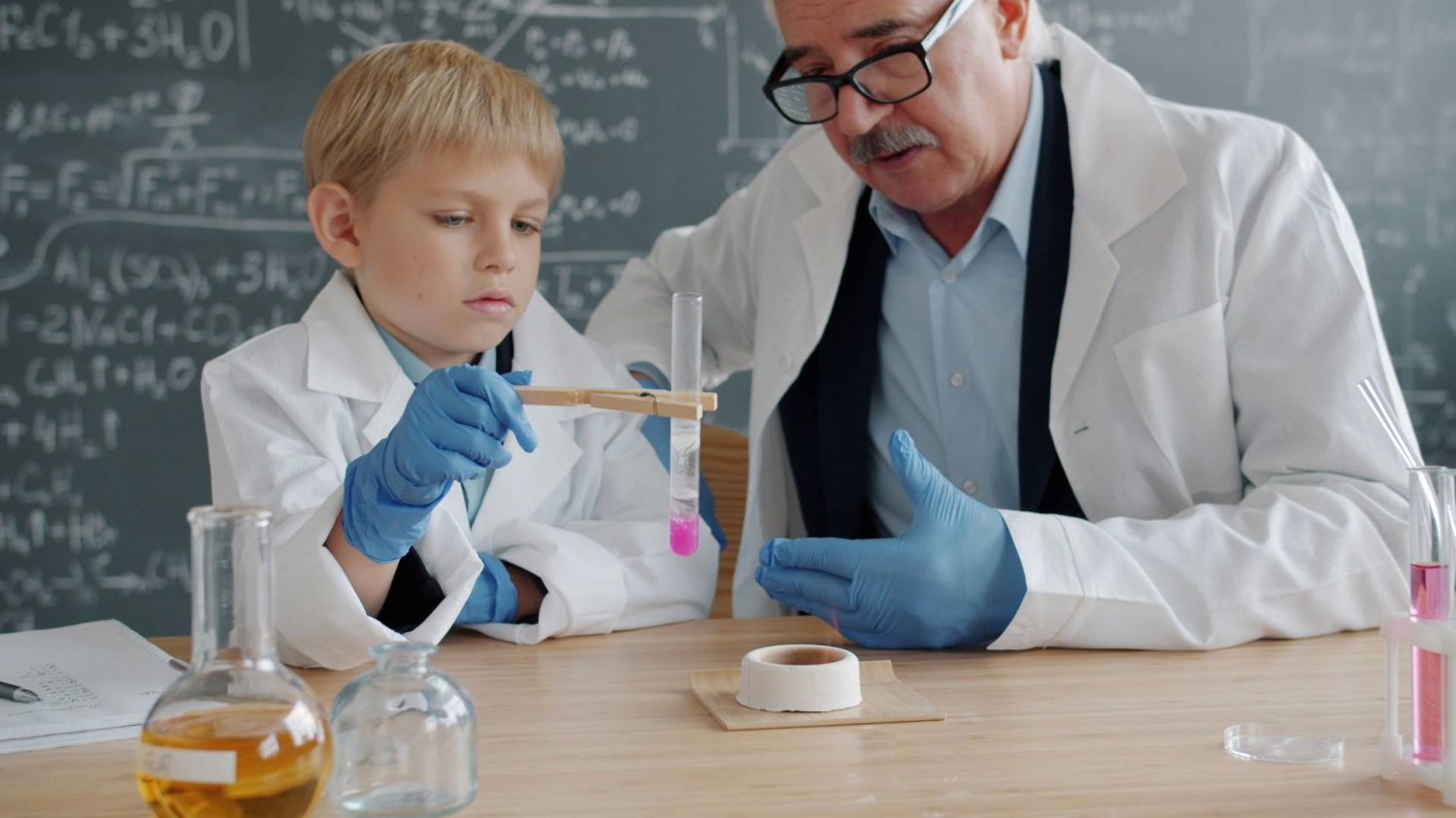 nauczyciel z uczniem robią eksperyment chemiczny nauczyciel z uczniem robią eksperyment chemiczny
