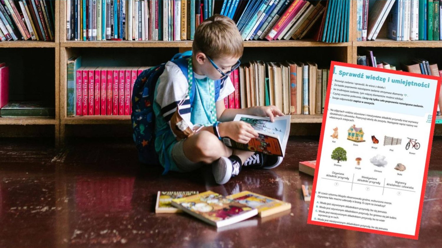 uczeń przegląda podręcznik w szkolnej bibliotece