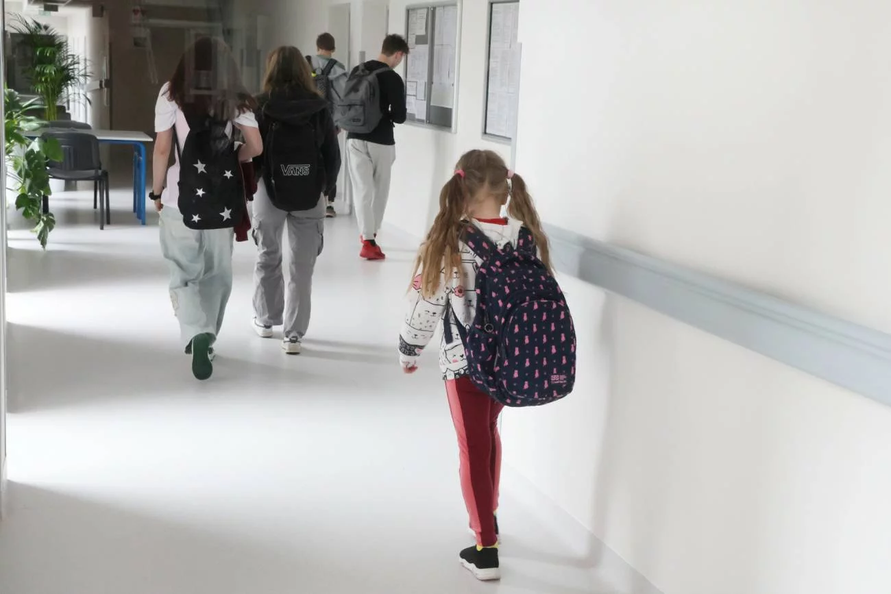 Samotna smutna dziewczynka idzie szkolnym korytarzem. Samotna smutna dziewczynka idzie szkolnym korytarzem.