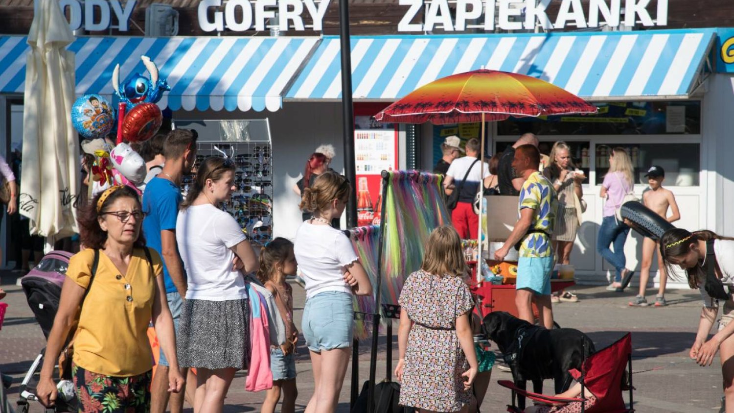 Dzieci czekają w kolejce, żeby kupić lody z automatu.