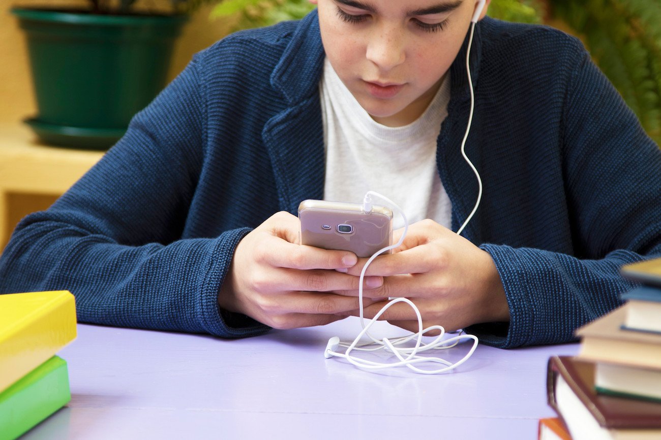 nastolatek z telefonem w klasie