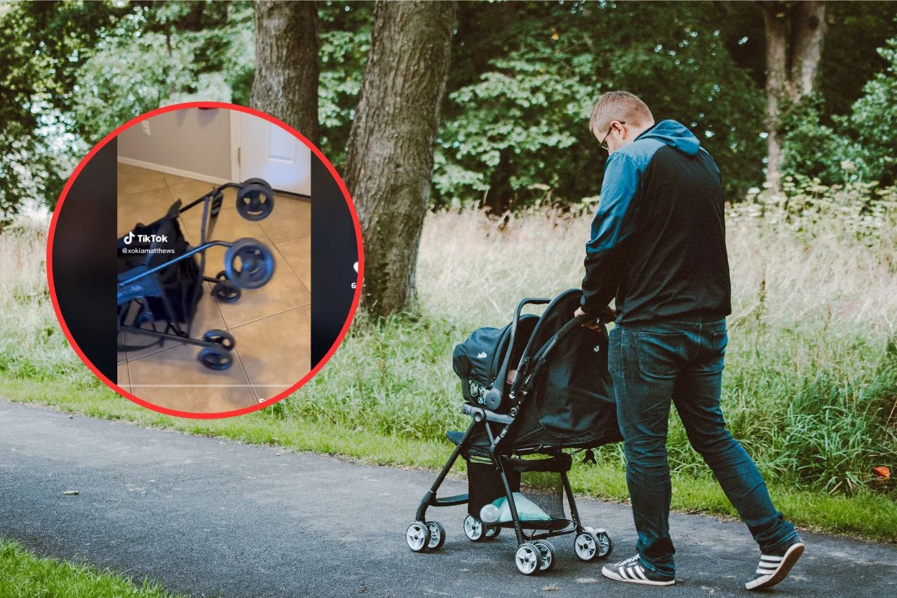Tata prowadzi wózek na spacerze.
