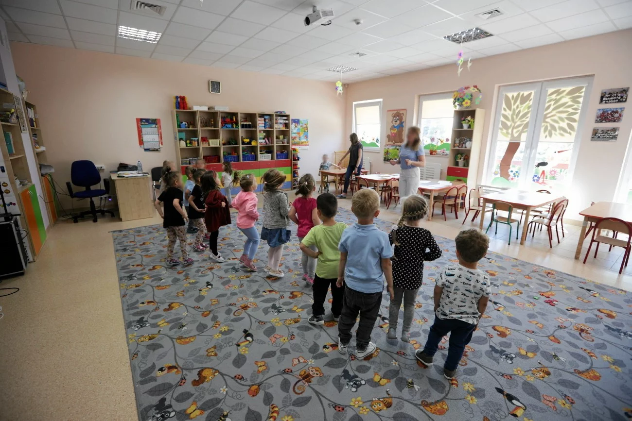 dzieci w przedszkolnej sali z nauczycielką dzieci w przedszkolnej sali z nauczycielką