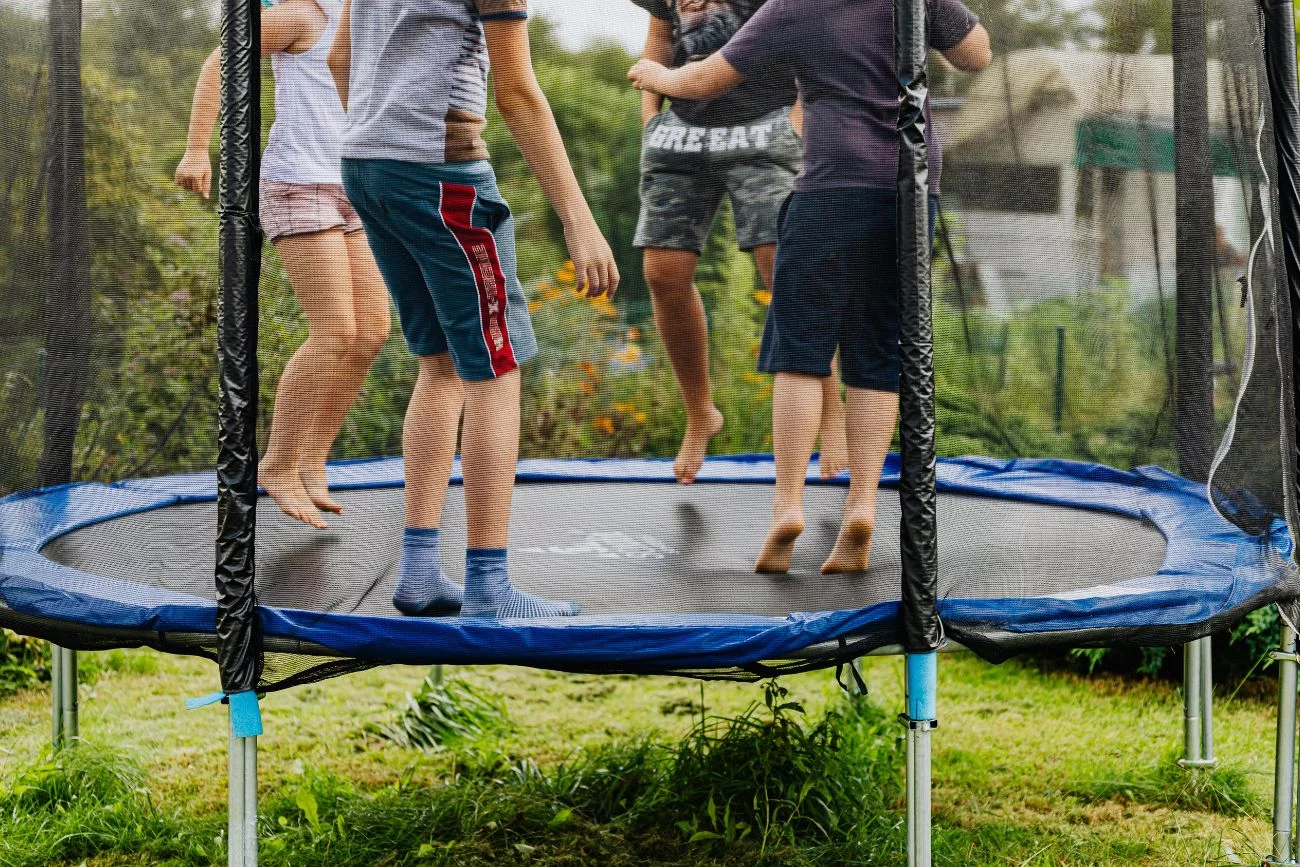 Dzieci skaczące na trampolinie.