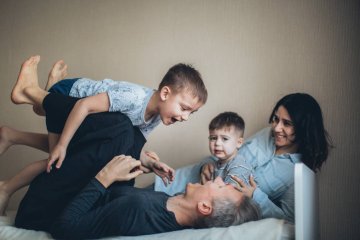 Rodzina spędza ze sobą wspólny czas na łóżku.