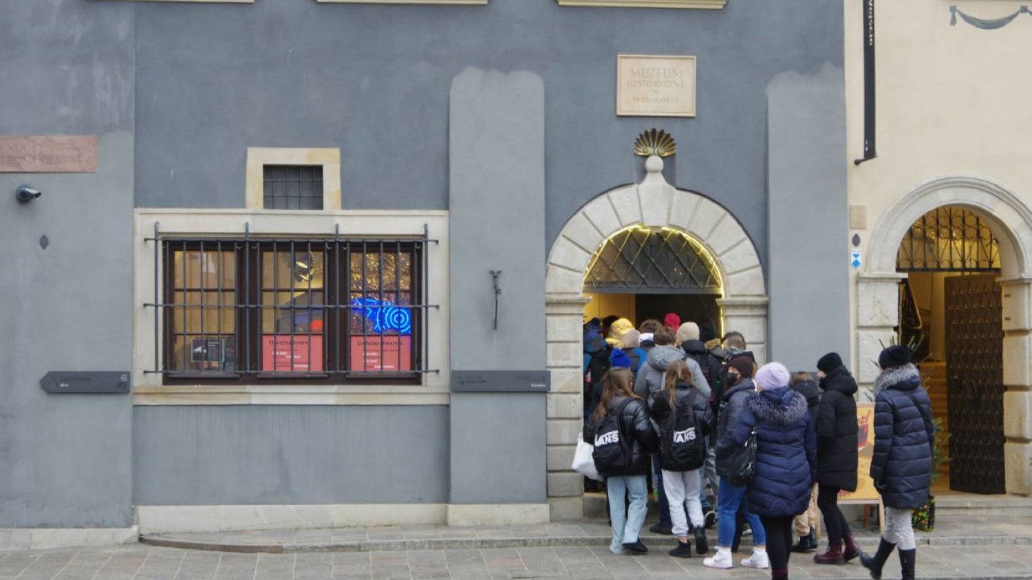 Grupa uczniów na szkolnej wycieczce wchodzi do muzeum.