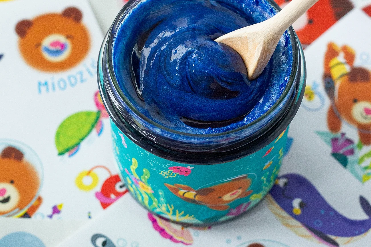 Miodziś Miód ze spiruliną jest przepysznie słodkim miodem wielokwiatowym o niebieskim kolorze, który zawdzięcza szczypcie spiruliny, czyli sproszkowanym mikroskopijnym algom morskim