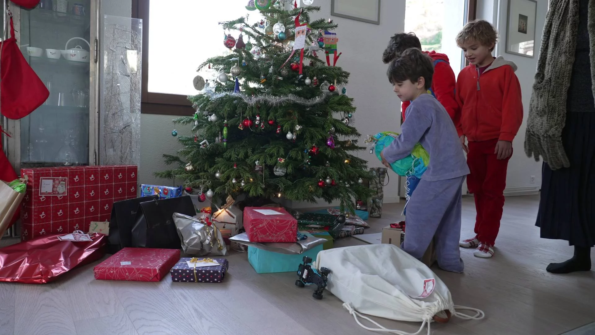 dzieci oglądają prezenty pod choinką