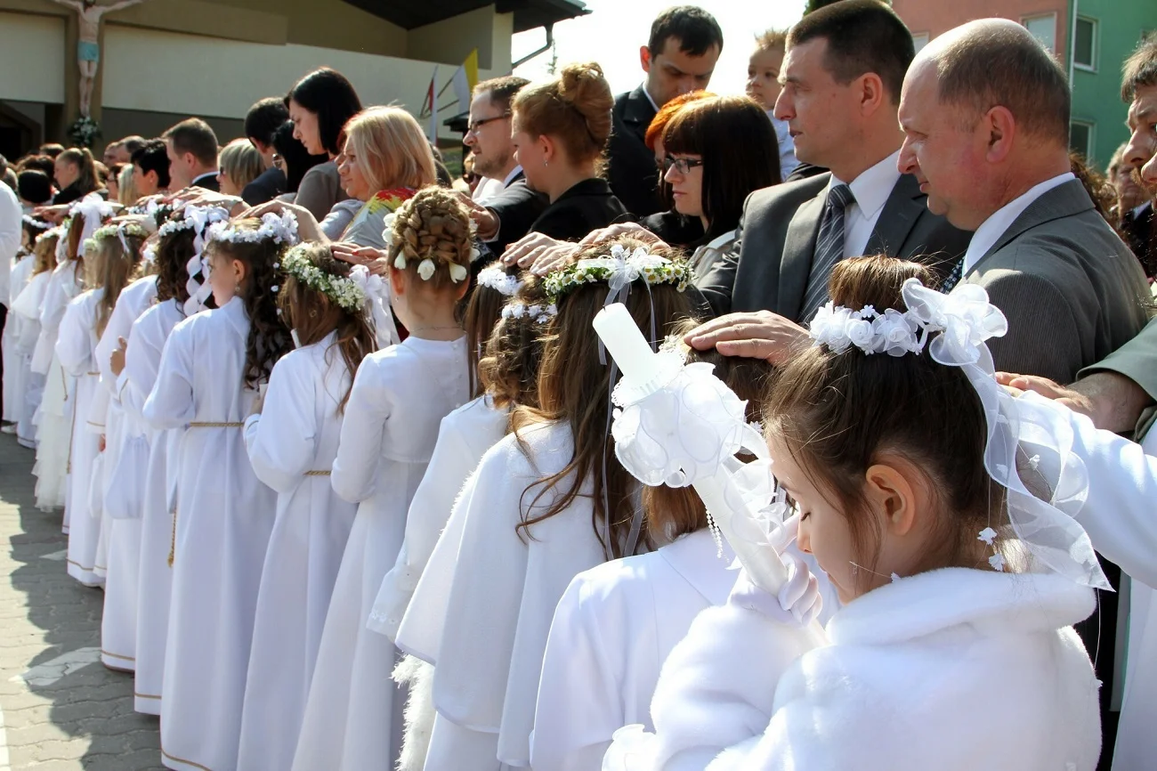 dzieci idące do pierwszej komunii