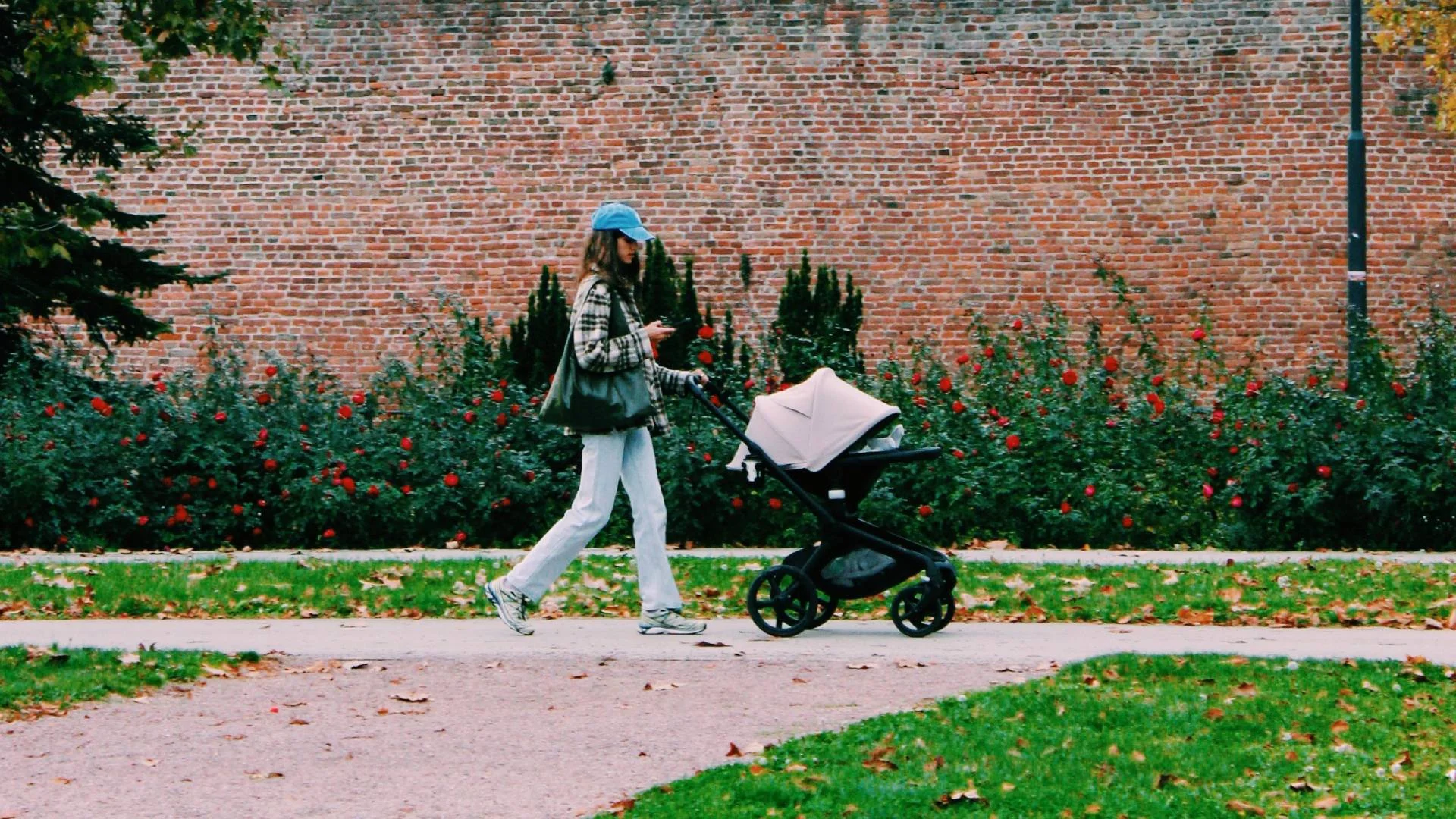 młoda mama z dzieckiem w wózku na spacerze
